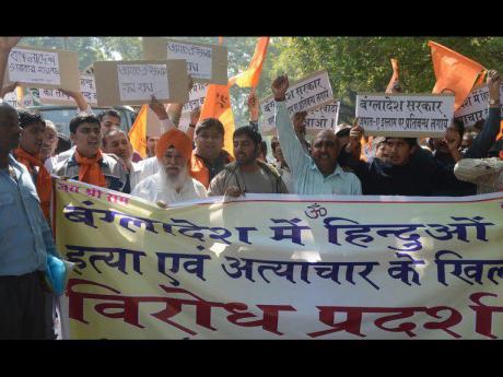 Activists from The Bajrang Dal and Visva Hindu Parishad (VHP) shout anti-Bangladesh slogans in New Delhi on March 6, 2013, during a protest against recent attacks against minority Hindus in Bangladesh. Bangladesh’s main opposition leader Khaleda Zia has condemned recent attacks on Hindus in different parts of the country allegedly by activists of fundamentalist Jamaat-e-Islami, demandING punishment to perpetrators of the attacks. AFP PHOTO/RAVEENDRAN (Photo credit should read RAVEENDRAN/AFP/Getty Images) 2013 AFP