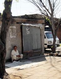 A man sits by a shop at a camp for Kashmiri migrants in Jammu Photographs: Archana Masih/Rediff.com