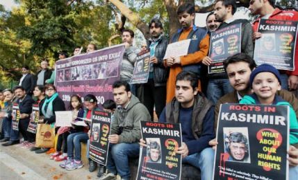 Members of Roots In Kashmir a Kashmiri Pandit Group campaigning for restoration of human rights and dignity in Kashnmir during a protest to mark the Kashmiri Pandit Exodus day and the 24th anniversary of their forced exile in New Delhi on Sunday. PTI