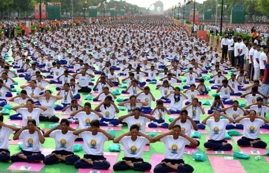 NEW, DELHI - INDIA: Indian Prime Minister Narendra Modi (not seen) performs yoga along with others at Rajpath during mass yoga session to mark the International Day of Yoga on June 21, 2015 in New Delhi, India. An estimated 40,000 people participated in the celebrations at Rajpath, with around two billion people taking part across the world. The yoga celebrations are being organised after the United Nations had in December last year declared June 21 as International Yoga Day. (Photo by Vinod Singh/Anadolu Agency/Getty Images)
