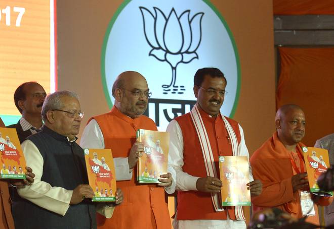 BJP president Amit Shah (second from left) releases the BJP manifesto for the U.P. Assembly elections, in Lucknow on Saturday. Union Minister Kalraj Mishra (left), U.P. BJP chief Keshav Prasad Maurya (third from left) and Gorakhpur MP Yogi Adityanath are also seen in the picture. | Photo Credit: Rajeev Bhatt.
